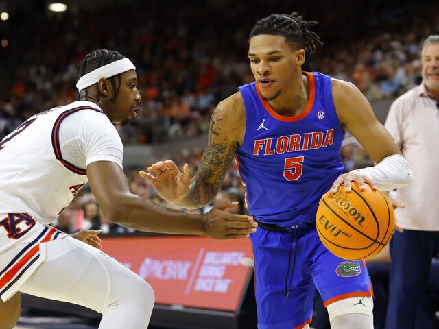 AUBURN, ALABAMA - FEBRUARY 8: Will Richard #5 of the Florida Gators drives against Denver Jones #2 of the Auburn Tigers during the first half at Neville Arena on February 8, 2025 in Auburn, Alabama.