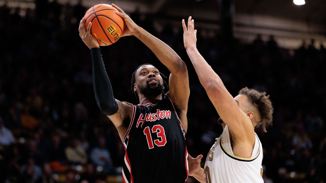 BOULDER, COLORADO - FEBRUARY 08: J'Wan Roberts #13 of the Houston Cougars shoots the ball against Elijah Malone #50 of the Colorado Buffaloes during the second half at the CU Events Center on February 08, 2025 in Boulder, Colorado.