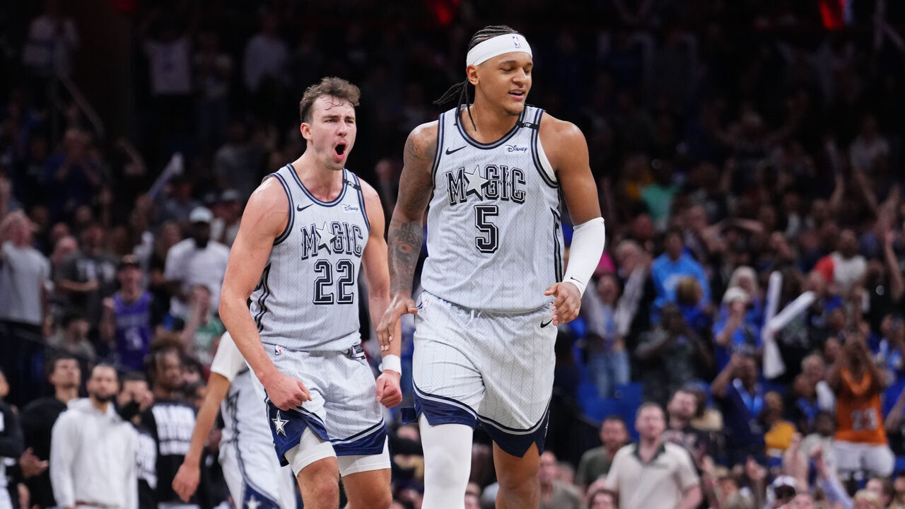 ORLANDO, FLORIDA - FEBRUARY 08: Franz Wagner #22 and Paolo Banchero #5 of the Orlando Magic celebrate after scoring against the San Antonio Spurs during the fourth quarter at Kia Center on February 08, 2025 in Orlando, Florida.