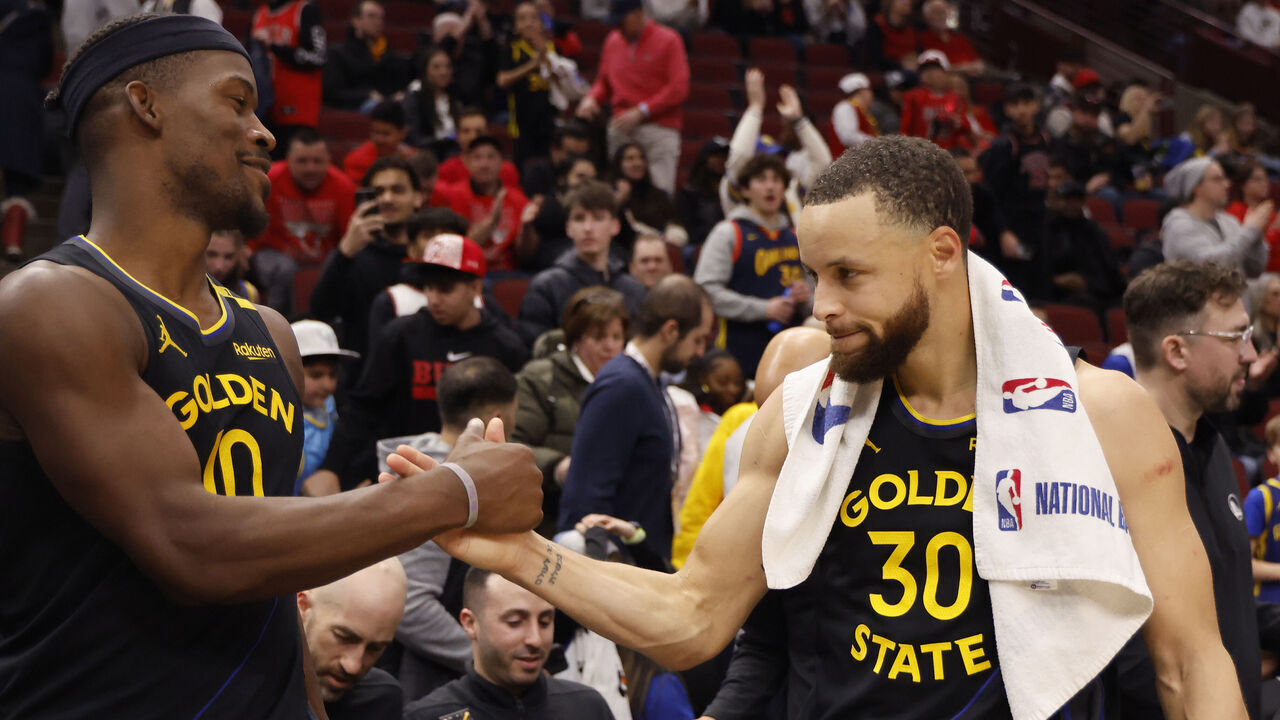 CHICAGO, ILLINOIS - FEBRUARY 08: Jimmy Butler #10 and Stephen Curry #30 of the Golden State Warriors celebrate after the game against the Chicago Bulls at the United Center on February 08, 2025 in Chicago, Illinois.