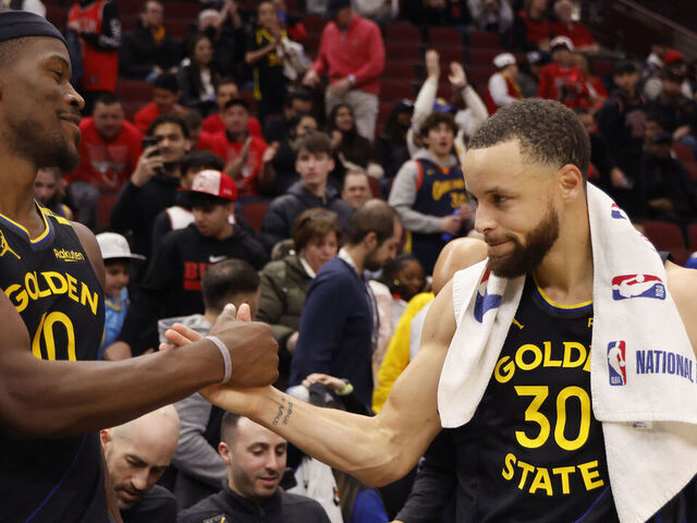 CHICAGO, ILLINOIS - FEBRUARY 08: Jimmy Butler #10 and Stephen Curry #30 of the Golden State Warriors celebrate after the game against the Chicago Bulls at the United Center on February 08, 2025 in Chicago, Illinois.