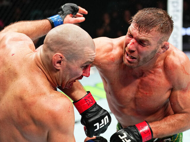 SYDNEY, AUSTRALIA - FEBRUARY 09: (R-L) Dricus Du Plessis of South Africa elbows Sean Strickland in the UFC middleweight championship fight during the UFC 312 event at Qudos Bank Arena on February 09, 2025 in Sydney, Australia.