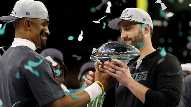 NEW ORLEANS, LOUISIANA - FEBRUARY 09: Head coach Nick Sirianni of the Philadelphia Eagles hands the Vince Lomardi Trophy to Jalen Hurts #1 after beating the Kansas City Chiefs 40-22 to win Super Bowl LIX at Caesars Superdome on February 09, 2025 in New Orleans, Louisiana.