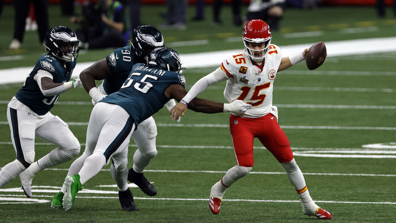NEW ORLEANS, LA - FEBRUARY 09: iQB Patrick Mahomes #15 of the Kansas City Chiefs tries to scramble away from DE Brandon Graham #55 of the Philadelphia Eagles in the third quarter during Super Bowl LIX between the Philadelphia Eagles and the Kansas City Chiefs on February 09, 2025, at the Caesars Superdome in New Orleans, LA.