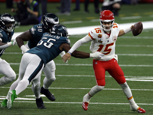 NEW ORLEANS, LA - FEBRUARY 09: iQB Patrick Mahomes #15 of the Kansas City Chiefs tries to scramble away from DE Brandon Graham #55 of the Philadelphia Eagles in the third quarter during Super Bowl LIX between the Philadelphia Eagles and the Kansas City Chiefs on February 09, 2025, at the Caesars Superdome in New Orleans, LA.