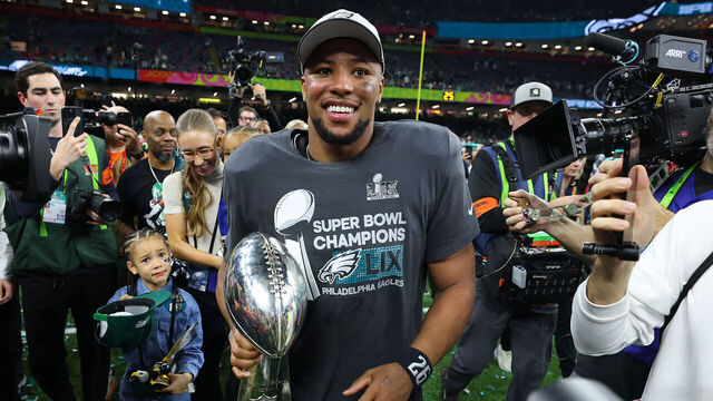 NEW ORLEANS, LOUISIANA - FEBRUARY 09: Saquon Barkley #26 of the Philadelphia Eagles celebrates with the Vince Lombardi Trophy after beating the Kansas City Chiefs 40-22 to win Super Bowl LIX at Caesars Superdome on February 09, 2025 in New Orleans, Louisiana.