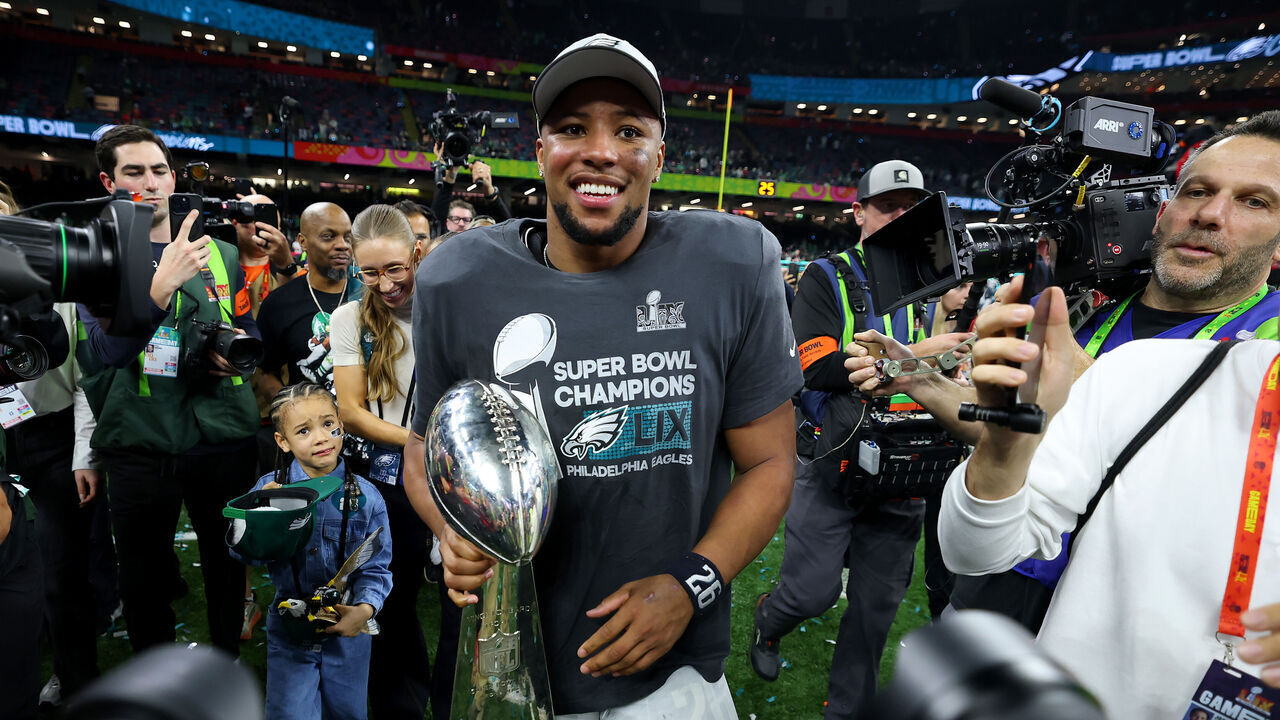 NEW ORLEANS, LOUISIANA - FEBRUARY 09: Saquon Barkley #26 of the Philadelphia Eagles celebrates with the Vince Lombardi Trophy after beating the Kansas City Chiefs 40-22 to win Super Bowl LIX at Caesars Superdome on February 09, 2025 in New Orleans, Louisiana.