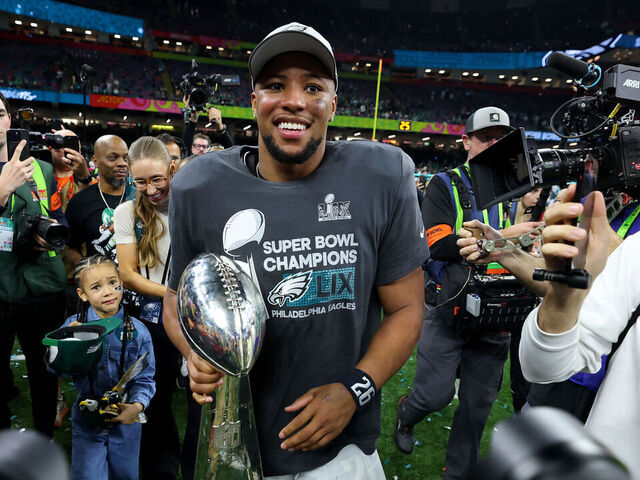 NEW ORLEANS, LOUISIANA - FEBRUARY 09: Saquon Barkley #26 of the Philadelphia Eagles celebrates with the Vince Lombardi Trophy after beating the Kansas City Chiefs 40-22 to win Super Bowl LIX at Caesars Superdome on February 09, 2025 in New Orleans, Louisiana.