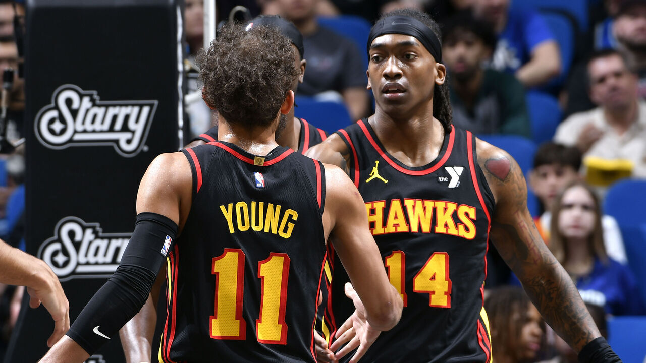 ORLANDO, FL - FEBRUARY 10: Terance Mann #14 of the Atlanta Hawks high fives Trae Young #11 during the game against the Orlando Magic on February 10, 2025 at Kia Center in Orlando, Florida. Mandatory Copyright Notice: Copyright 2025 NBAE