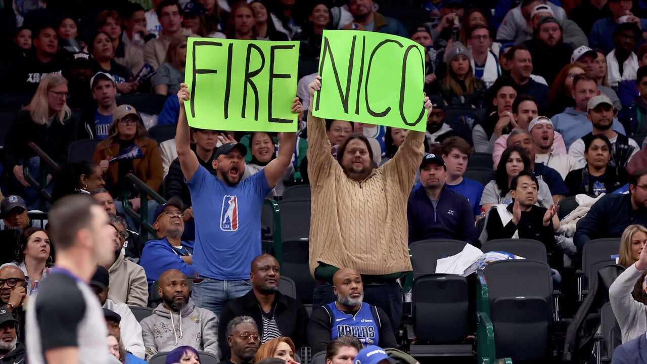 DALLAS, TEXAS - FEBRUARY 10: Dallas Mavericks fans hold up a sign referring to Mavs general manager Nico Harrison during the game against the Sacramento Kings at American Airlines Center on February 10, 2025 in Dallas, Texas.