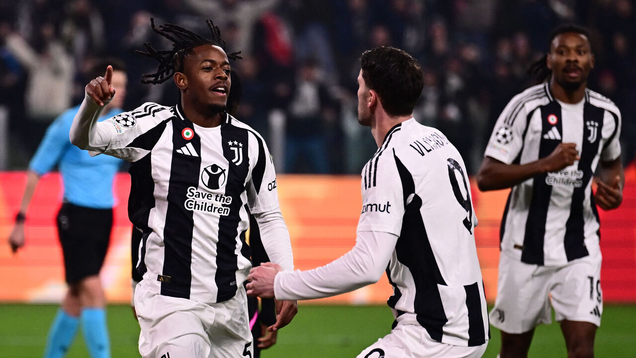 Juventus' Belgian forward #51 Samuel Mbangula celebrates scoring his team's second goal with Juventus' Serbian forward #09 Dusan Vlahovic during the UEFA Champions League knockout phase play-off 1st leg football match between Juventus and PSV Eindhoven at the Allianz stadium in Turin, on February 11, 2025.