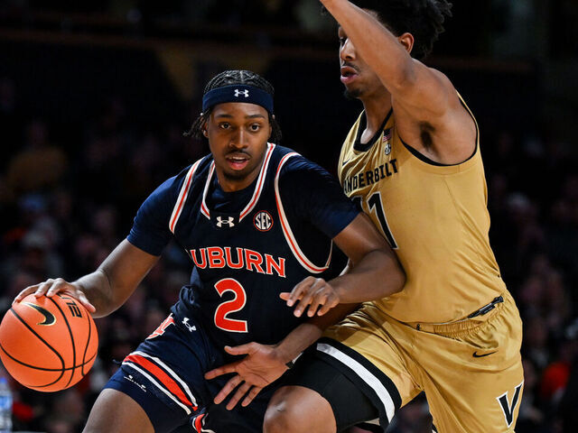 NASHVILLE, TENNESSEE - FEBRUARY 11: Denver Jones #2 of the Auburn Tigers drives to the basket against AJ Hoggard #11 of the Vanderbilt Commodores in the first half at Vanderbilt University Memorial Gymnasium on February 11, 2025 in Nashville, Tennessee.