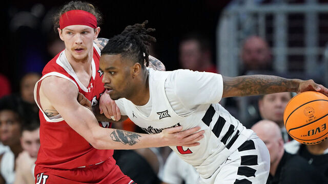 CINCINNATI, OHIO - FEBRUARY 11: Jizzle James #2 of the Cincinnati Bearcats dribbles the ball while being guarded by Gabe Madsen #55 of the Utah Utes in the second half at Fifth Third Arena on February 11, 2025 in Cincinnati, Ohio.