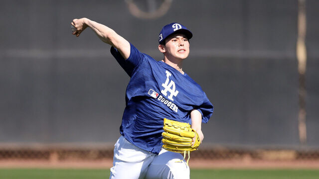 GLENDALE, ARIZONA - FEBRUARY 11: Roki Sasaki #11 of the Los Angeles Dodgers throw during workouts at Camelback Ranch on February 11, 2025 in Glendale, Arizona.