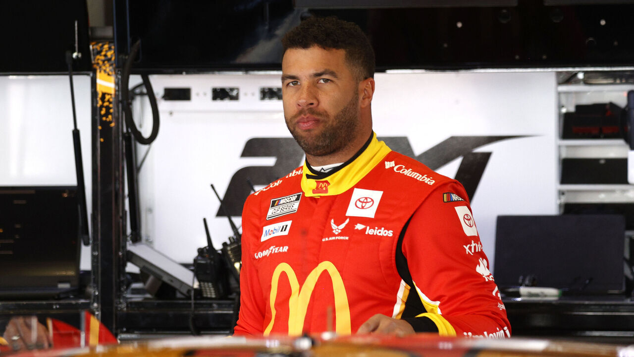 DAYTONA BEACH, FL - FEBRUARY 12: Bubba Wallace (#23 23XI Racing McDonald?s Toyota) talks with members of his crew during practice for the NASCAR Cup Series Daytona 500 on February 12, 2025 at Daytona International Speedway in Daytona Beach, FL.