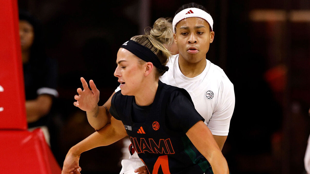 RALEIGH, NORTH CAROLINA - FEBRUARY 13: Haley Cavinder #14 of the Miami Hurricanes moves the ball against Zoe Brooks #35 of the NC State Wolfpack during the first half at Reynolds Coliseum on February 13, 2025 in Raleigh, North Carolina.