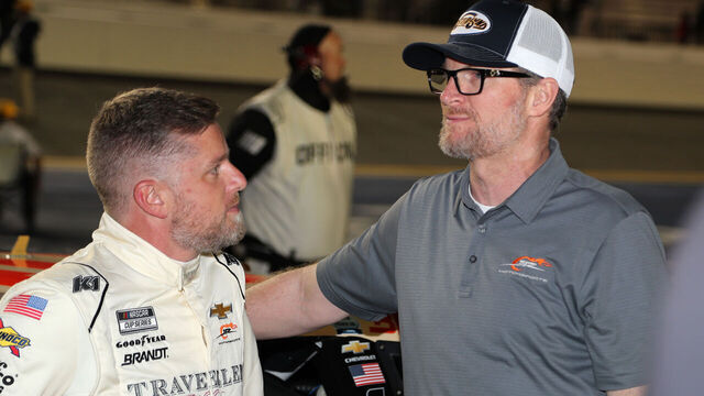 DAYTONA BEACH, FL - FEBRUARY 13: Justin Allgaier (#40 JR Motorsports Traveller Whiskey Chevrolet) talks with team owner Dale Earnhardt Jr. prior to the running of the NASCAR Cup Series Duel 1 at Daytona on February 13, 2025 at Daytona International Speedway in Daytona Beach, FL.