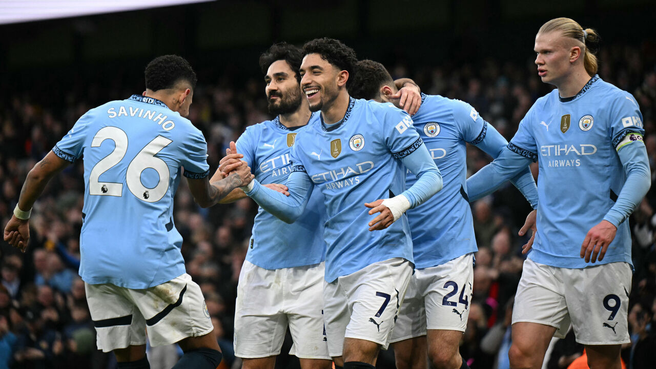 Manchester City's Egyptian striker #07 Omar Marmoush (C) celebrates with teammates after scoring his and City's third goal during the English Premier League football match between Manchester City and Newcastle United at the Etihad Stadium in Manchester, north west England, on February 15, 2025.