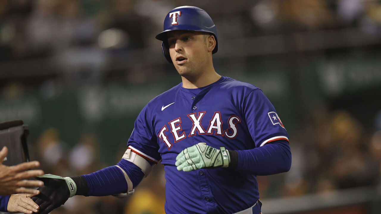 OAKLAND, CA - SEPTEMBER 24: Nathaniel Lowe #30 of the Texas Rangers is congratulated at the dugout after hitting a home run during the game against the Oakland Athletics at the Oakland Coliseum on September 24, 2024 in Oakland, California. The Athletics defeated the Rangers 5-4.