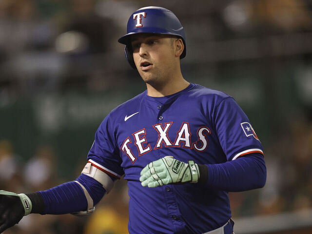 OAKLAND, CA - SEPTEMBER 24: Nathaniel Lowe #30 of the Texas Rangers is congratulated at the dugout after hitting a home run during the game against the Oakland Athletics at the Oakland Coliseum on September 24, 2024 in Oakland, California. The Athletics defeated the Rangers 5-4.