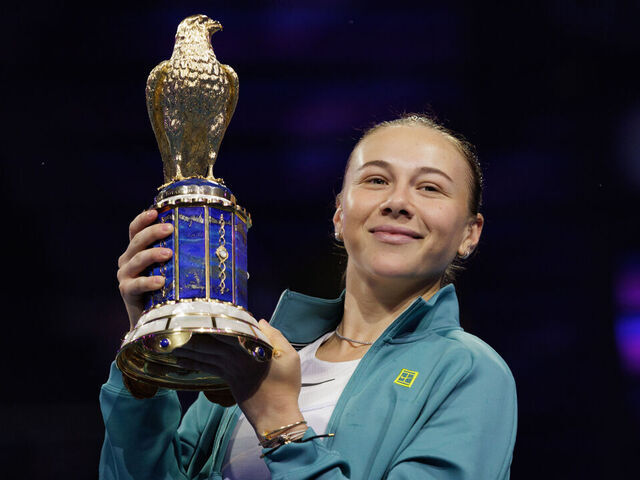 Doha, Qatar - February 15: Amanda Anisimova of the United States holds the trophy after winning against Jelena Ostapenko of Latvia during the Qatar TotalEnergies Open, part of the Hologic WTA Tour at Khalifa International Tennis and Squash Complex on February 15, 2025 in Doha, Qatar.
