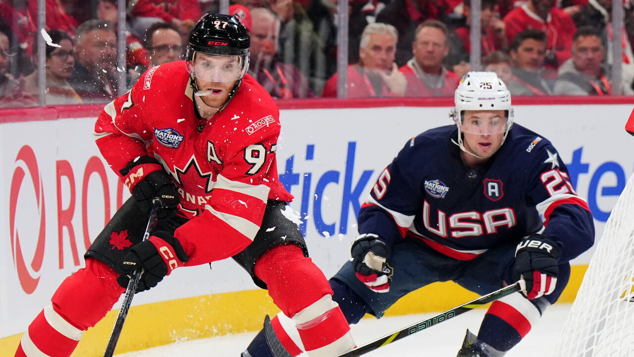 MONTREAL, QUEBEC - FEBRUARY 15: Connor McDavid #97 of Team Canada passes the puck as Charlie McAvoy #25 of Team United States looks on during the third period of the 4 Nations Face-Off game between the United States and Canada at Bell Centre on February 15, 2025 in Montreal, Quebec.