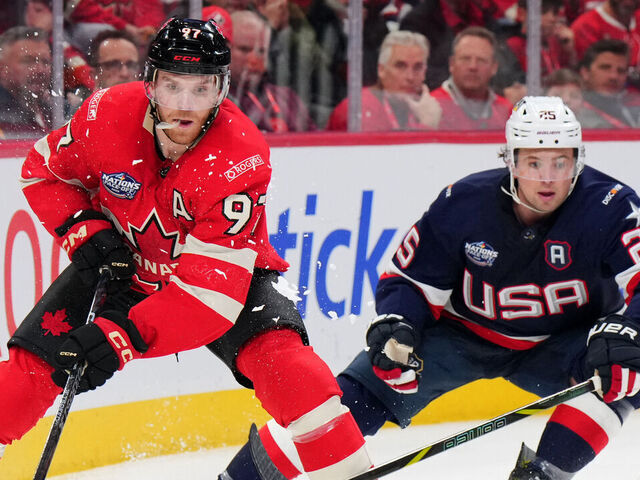 MONTREAL, QUEBEC - FEBRUARY 15: Connor McDavid #97 of Team Canada passes the puck as Charlie McAvoy #25 of Team United States looks on during the third period of the 4 Nations Face-Off game between the United States and Canada at Bell Centre on February 15, 2025 in Montreal, Quebec.