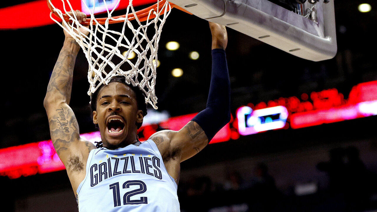 NEW ORLEANS, LOUISIANA - DECEMBER 26: Ja Morant #12 of the Memphis Grizzlies dunks the gall during overtime of an NBA game against the New Orleans Pelicans at Smoothie King Center on December 26, 2023 in New Orleans, Louisiana. The Memphis Grizzlies won the game 116 - 115 over the New Orleans Pelicans.
