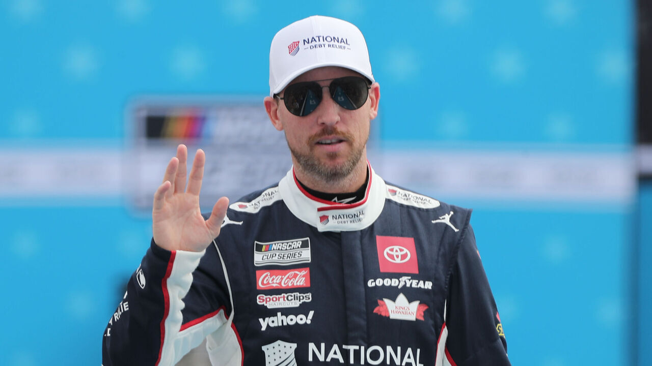 DAYTONA BEACH, FL - FEBRUARY 16: Denny Hamlin (#11 Joe Gibbs Racing National Debt Relief Toyota) waves to the fans prior to the running of the NASCAR Cup Series Daytona 500 on February 16, 2025 at Daytona International Speedway in Daytona Beach, FL.
