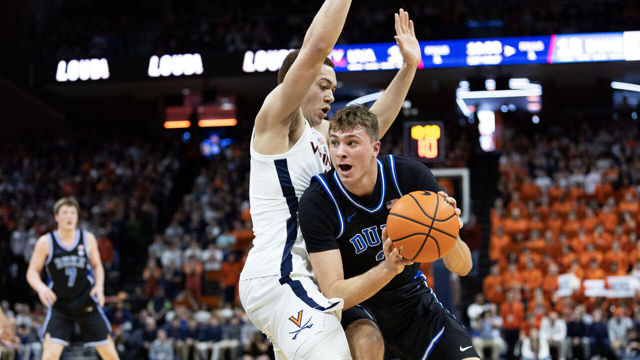 CHARLOTTESVILLE, VIRGINIA - FEBRUARY 17: Cooper Flagg #2 of the Duke Blue Devils drives past Elijah Saunders #2 of the Virginia Cavaliers in the first half during a game at John Paul Jones Arena on February 17, 2025 in Charlottesville, Virginia.