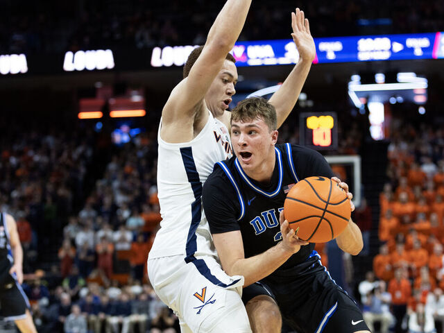 CHARLOTTESVILLE, VIRGINIA - FEBRUARY 17: Cooper Flagg #2 of the Duke Blue Devils drives past Elijah Saunders #2 of the Virginia Cavaliers in the first half during a game at John Paul Jones Arena on February 17, 2025 in Charlottesville, Virginia.