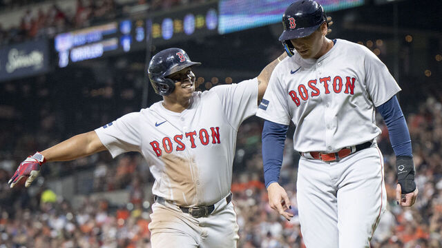 BALTIMORE, MARYLAND - AUGUST 16: Rafael Devers #11 of the Boston Red Sox reacts with Triston Casas #36 of the Boston Red Sox after hitting a two-run home run during the third inning of a game against the Baltimore Orioles at Oriole Park at Camden Yards on August 16, 2024 in Baltimore, Maryland.