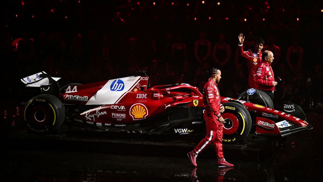 (From L) Ferrari's British driver Lewis Hamilton, Ferrari's French team principal Frederic Vasseur and Ferrari's Monaco driver Charles Leclerc stand by the new Formula 1 car of Ferrari Formula One Team during the Formula One - 2025 season launch "F1 75 LIVE" event at the O2, in London, on February 18, 2025.