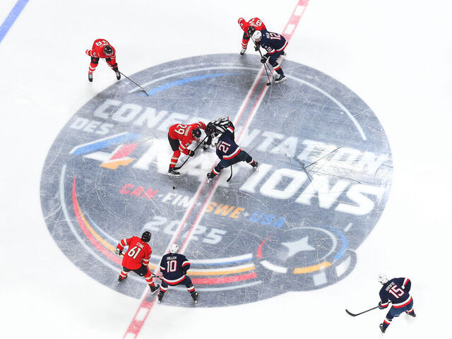 MONTREAL, QUEBEC - FEBRUARY 15: Nathan MacKinnon #29 of Team Canada and Dylan Larkin #21 of Team United States face off at center ice during the second period of the 4 Nations Face-Off game between the United States and Canada at Bell Centre on February 15, 2025 in Montreal, Quebec.