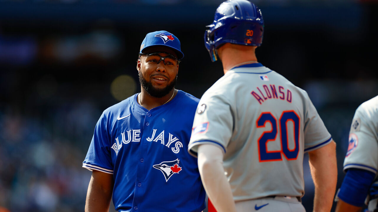 TORONTO, CANADA - SEPTEMBER 11: Vladimir Guerrero Jr. #27 of the Toronto Blue Jays talks with Pete Alonso #20 of the New York Mets in the fifth inning during a game at Rogers Centre on September 11, 2024 in Toronto, Canada.