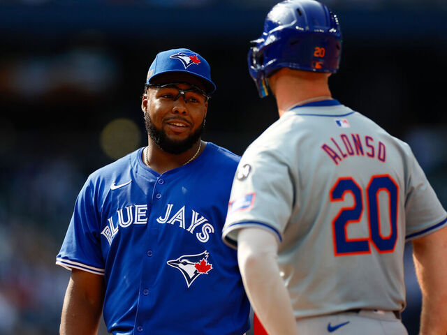 TORONTO, CANADA - SEPTEMBER 11: Vladimir Guerrero Jr. #27 of the Toronto Blue Jays talks with Pete Alonso #20 of the New York Mets in the fifth inning during a game at Rogers Centre on September 11, 2024 in Toronto, Canada.