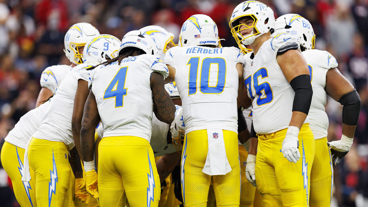 HOUSTON, TEXAS - JANUARY 11: Quarterback Justin Herbert #10 of the Los Angeles Chargers stands in a huddle during the first half of an AFC Wild Card game against the Houston Texans at NRG Stadium on January 11, 2025 in Houston, Texas.