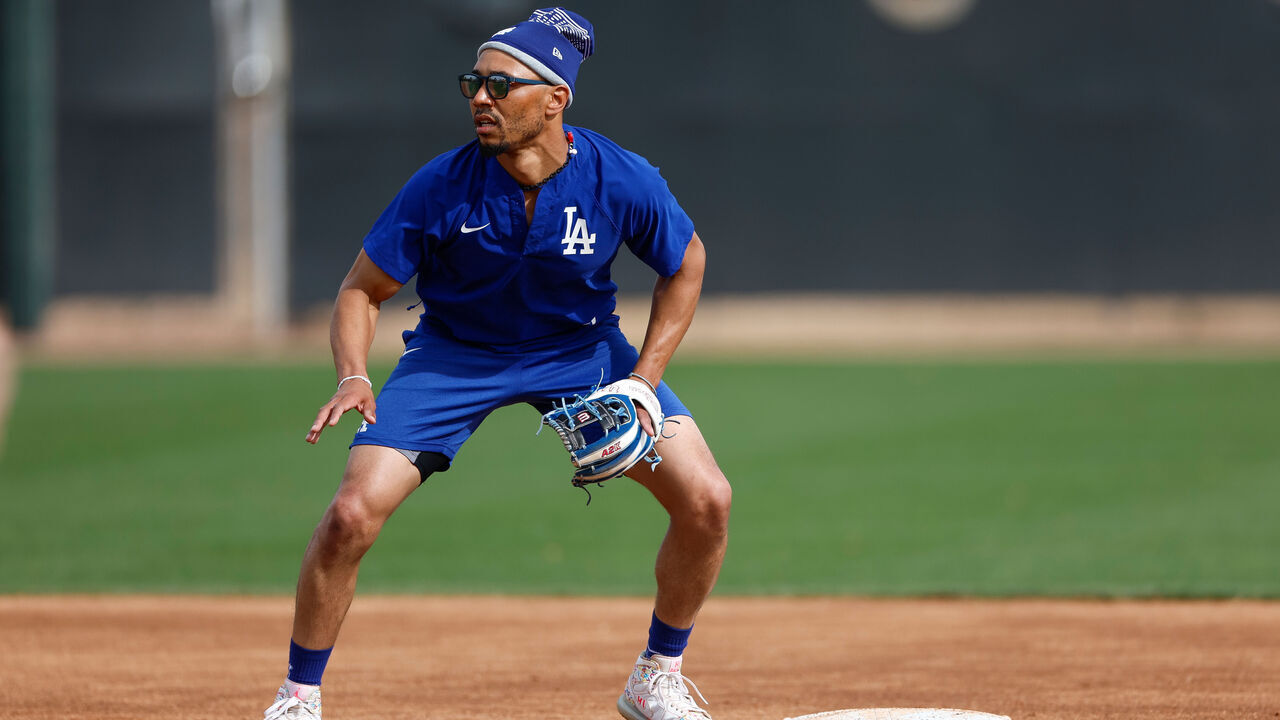 GLENDALE, ARIZONA - FEBRUARY 13: Mookie Betts #50 of the Los Angeles Dodgers participates in a fielding drill during spring training workouts at Camelback Ranch on February 13, 2025 in Glendale, Arizona.
