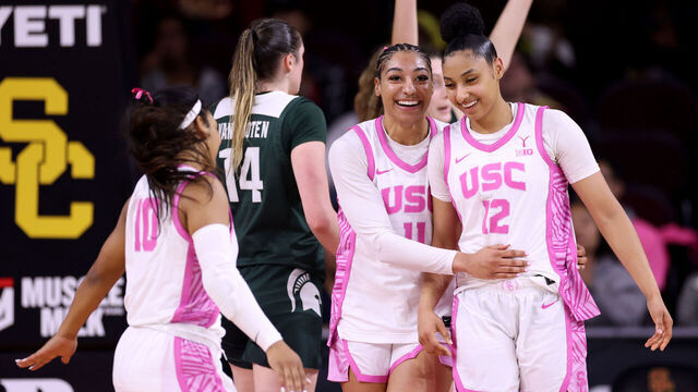 LOS ANGELES, CALIFORNIA - FEBRUARY 19: JuJu Watkins #12 of the USC Trojans laughs with Kennedy Smith #11 after a Michigan State Spartans foul during the first half at Galen Center on February 19, 2025 in Los Angeles, California.