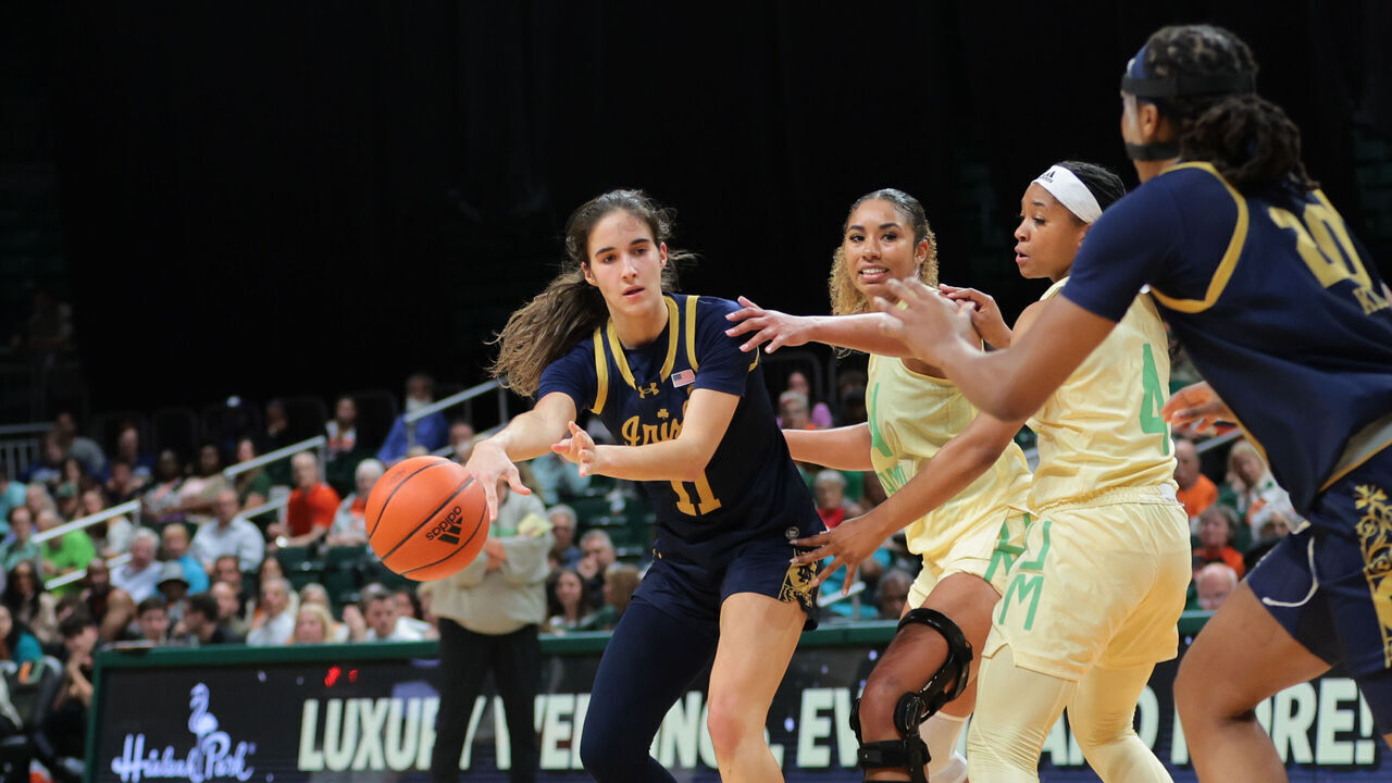 CORAL GABLES, FLORIDA - FEBRUARY 20: Sonia Citron #11 of the Notre Dame Fighting Irish passes the basketball to Liatu King #20 during the fourth quarter at Watsco Center on February 20, 2025 in Coral Gables, Florida.