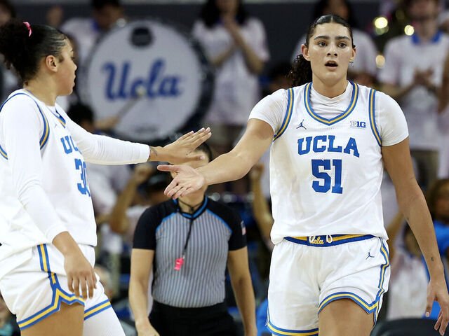 LOS ANGELES, CALIFORNIA - FEBRUARY 20: Lauren Betts #51 of the UCLA Bruins celebrates a basket with teammates Timea Gardiner #30 during the second quarter against the Illinois Fighting Illini at UCLA Pauley Pavilion on February 20, 2025 in Los Angeles, California.