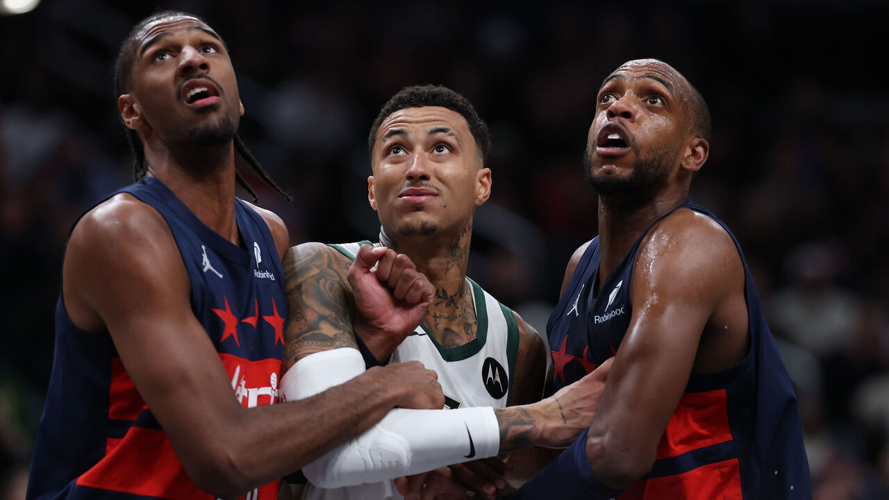 WASHINGTON, DC - FEBRUARY 21: Kyle Kuzma #18 of the Milwaukee Bucks is boxed out by Khris Middleton #32 and Alex Sarr #20 of the Washington Wizards during the second half at Capital One Arena on February 21, 2025 in Washington, DC.
