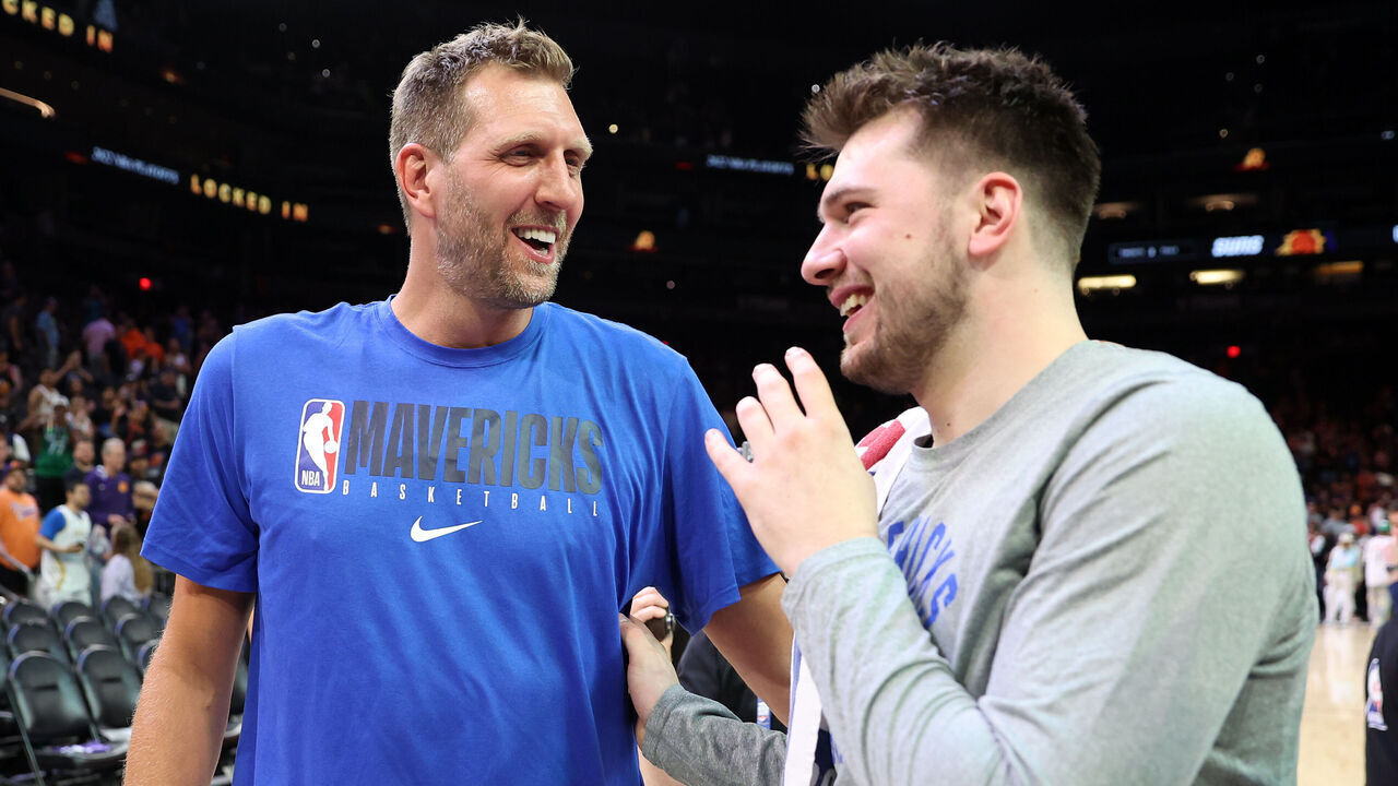 PHOENIX, ARIZONA - MAY 15: Former Dallas Mavericks player Dirk Nowitzki talks with Luka Doncic #77 of the Dallas Mavericks after the Mavericks defeated the Suns 123-90 in Game Seven of the 2022 NBA Playoffs Western Conference Semifinals at Footprint Center on May 15, 2022 in Phoenix, Arizona. NOTE TO USER: User expressly acknowledges and agrees that, by downloading and/or using this photograph, User is consenting to the terms and conditions of the Getty Images License Agreement.