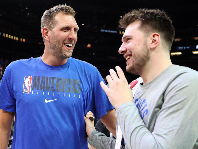 PHOENIX, ARIZONA - MAY 15: Former Dallas Mavericks player Dirk Nowitzki talks with Luka Doncic #77 of the Dallas Mavericks after the Mavericks defeated the Suns 123-90 in Game Seven of the 2022 NBA Playoffs Western Conference Semifinals at Footprint Center on May 15, 2022 in Phoenix, Arizona. NOTE TO USER: User expressly acknowledges and agrees that, by downloading and/or using this photograph, User is consenting to the terms and conditions of the Getty Images License Agreement.
