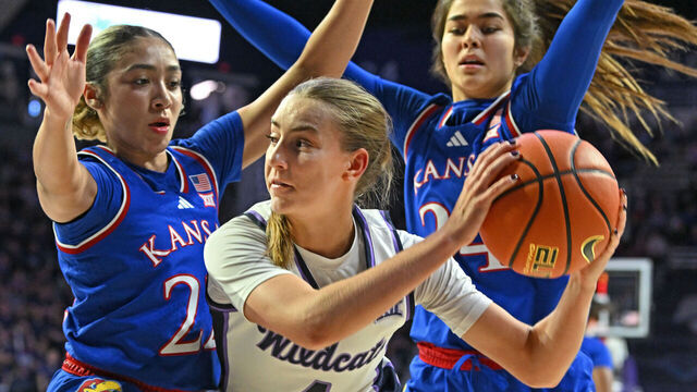 MANHATTAN, KS - FEBRUARY 22: Serena Sundell #4 of the Kansas State Wildcats receives pressure from defenders Sania Copeland #22 and Regan Williams #24 of the Kansas Jayhawks, in the second half at Bramlage Coliseum on February 22, 2025 in Manhattan, Kansas.