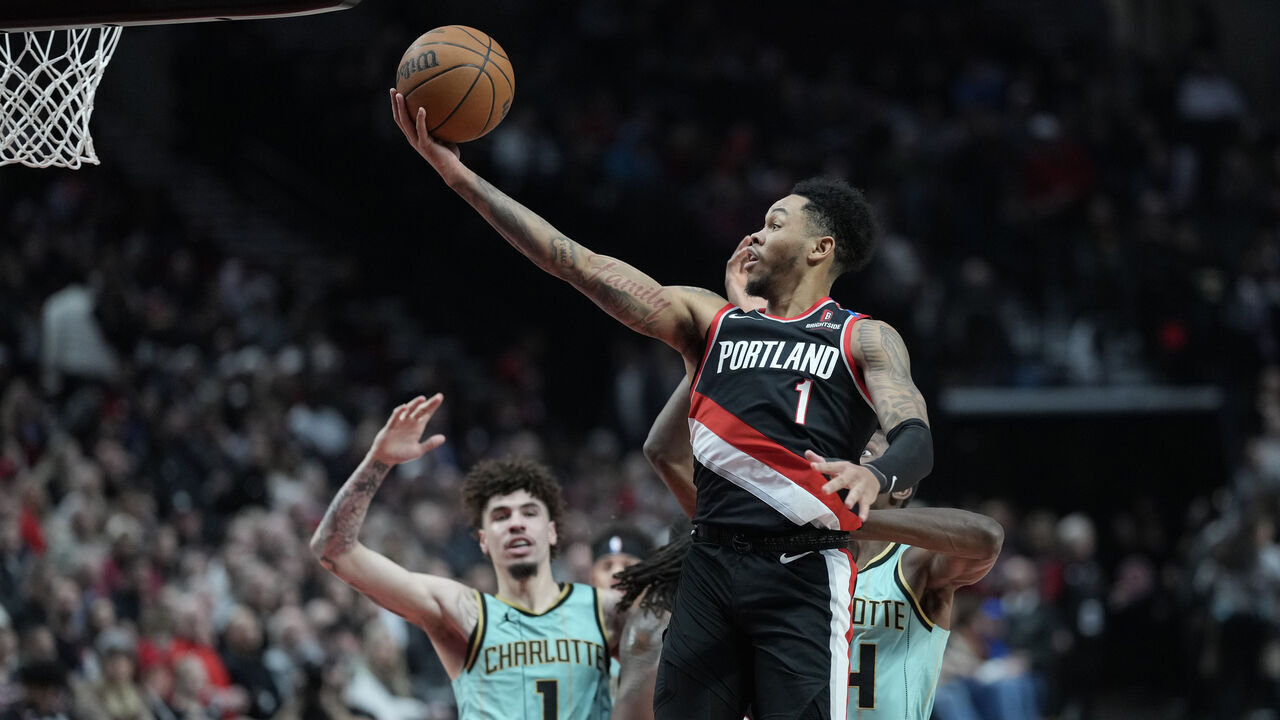 PORTLAND, OREGON - FEBRUARY 22: Anfernee Simons #1 of the Portland Trail Blazers shoots the ball past Moussa Diabate (R) #14 of the Charlotte Hornets during the first half at Moda Center on February 22, 2025 in Portland, Oregon.