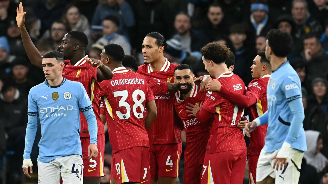 Liverpool's Egyptian striker #11 Mohamed Salah (C) celebrates scoring the opening goal during the English Premier League football match between Manchester City and Liverpool at the Etihad Stadium in Manchester, north west England, on February 23, 2025.