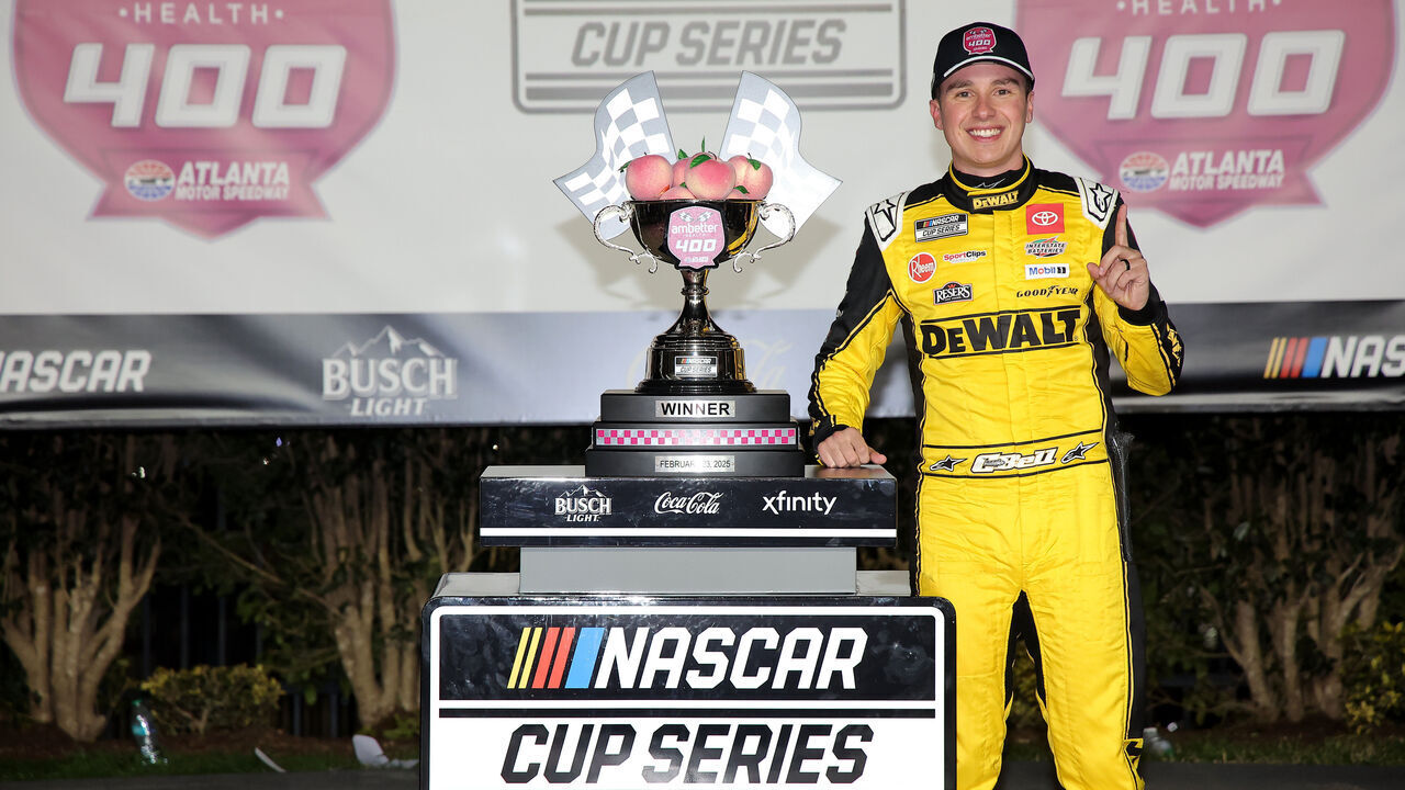 HAMPTON, GEORGIA - FEBRUARY 23: Christopher Bell, driver of the #20 DEWALT Toyota, celebrates in victory lane after winning the NASCAR Cup Series Ambetter Health 400 at Atlanta Motor Speedway on February 23, 2025 in Hampton, Georgia.