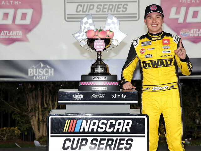 HAMPTON, GEORGIA - FEBRUARY 23: Christopher Bell, driver of the #20 DEWALT Toyota, celebrates in victory lane after winning the NASCAR Cup Series Ambetter Health 400 at Atlanta Motor Speedway on February 23, 2025 in Hampton, Georgia.