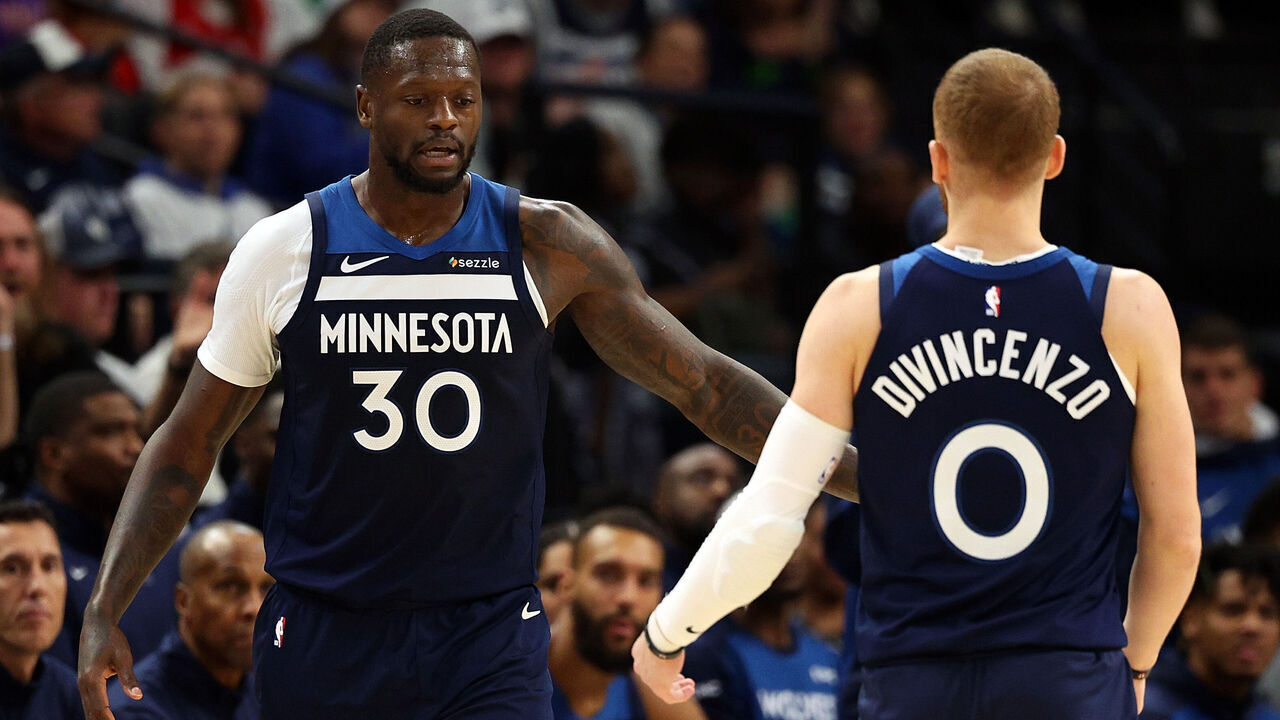 MINNEAPOLIS, MINNESOTA - OCTOBER 26: Julius Randle #30 interacts with Donte DiVincenzo #0 of the Minnesota Timberwolves in the third quarter of the home opener against the Toronto Raptors at Target Center on October 26, 2024 in Minneapolis, Minnesota. The Timberwolves defeated the Raptors 112-101.